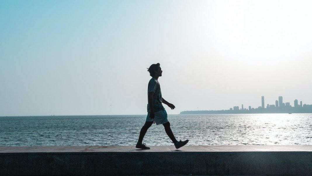 man walking near body of water